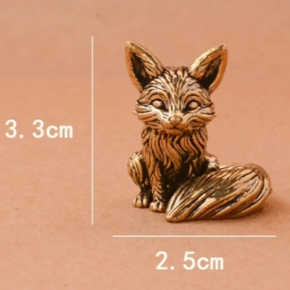 Small brass animal ornament figurine with detailed finish placed on a desk as decorative accent
