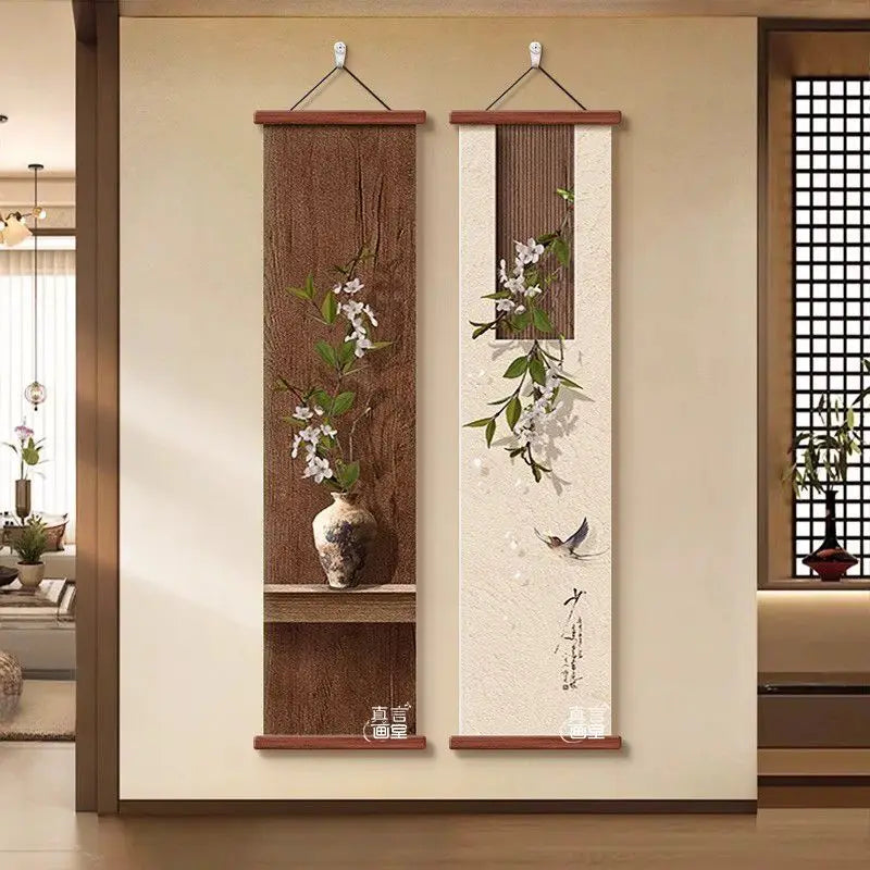 Two vertical wall art pieces with floral designs hanging on a beige wall.