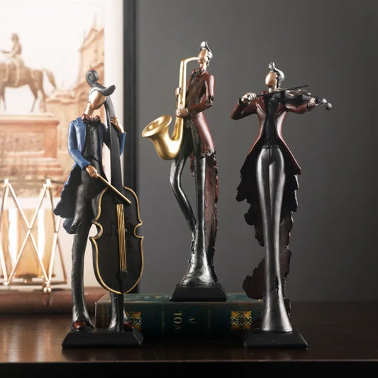 Three musical instrument figurines on a wooden surface with a blurred background