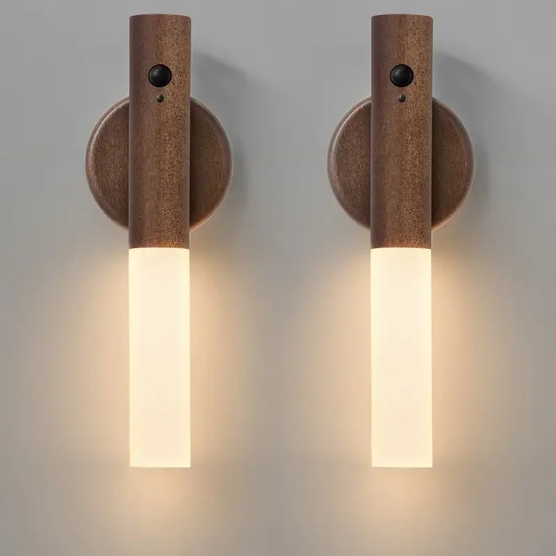 Three wooden wall sconces with light bulbs on a gray background