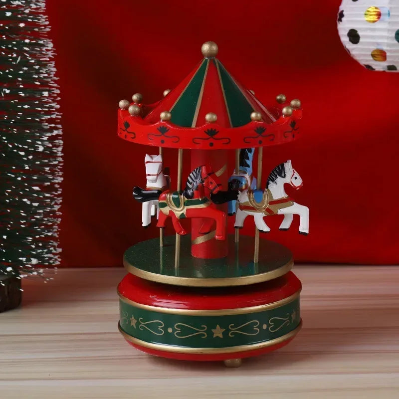 Decorative carousel toy with horses on a wooden surface against a red background.