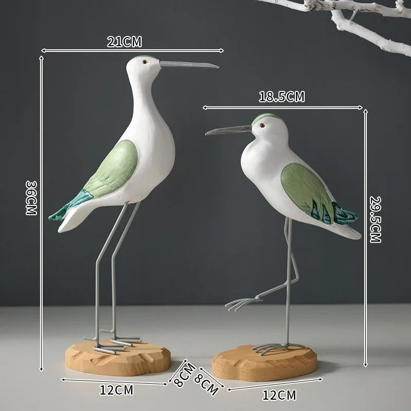 Two bird-shaped sculptures with measurements on a dark background