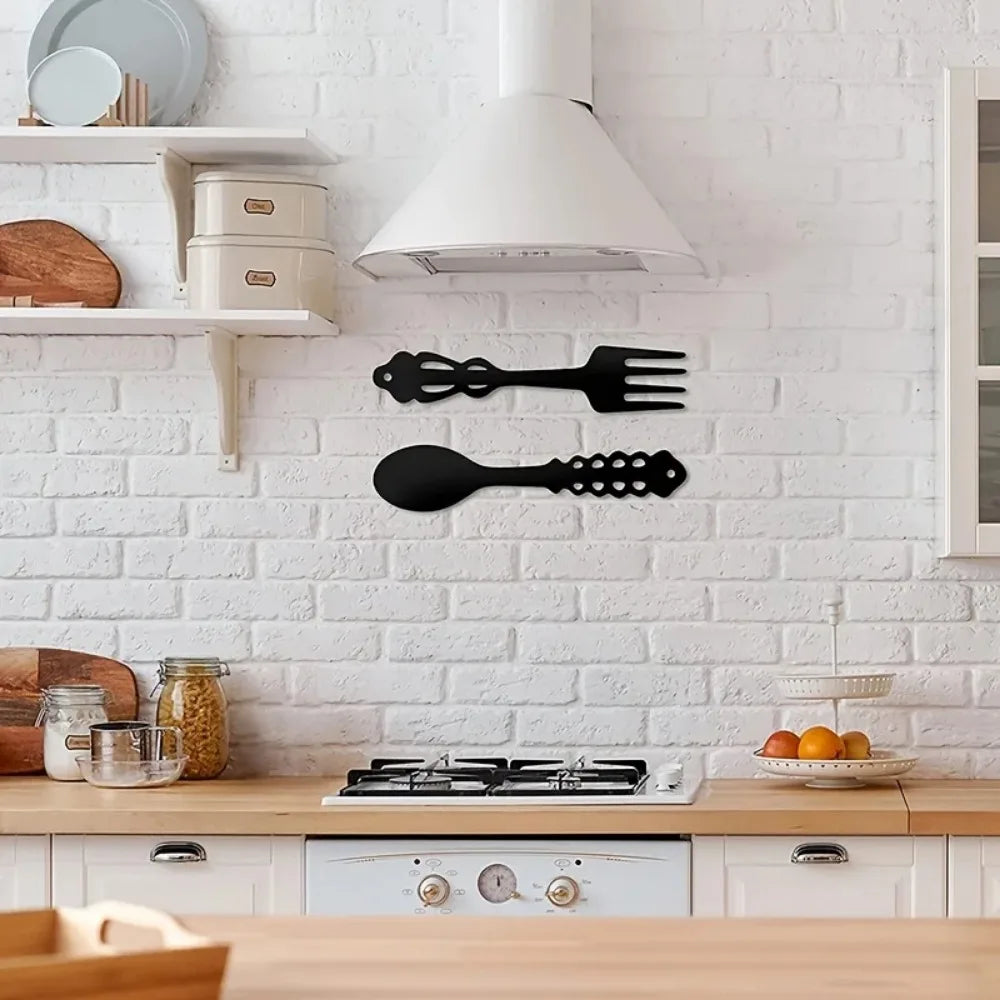 Rustic black metal spoon and fork kitchen wall decor mounted on white brick wall