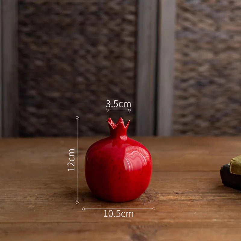 Red decorative pomegranate with measurements on a wooden surface