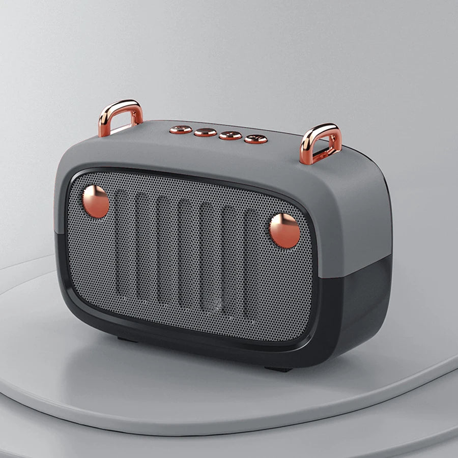 Gray and rose gold portable speaker on a light gray background
