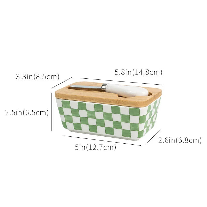 Green and white checkered butter dish with wooden lid and knife, showing dimensions on a white background.