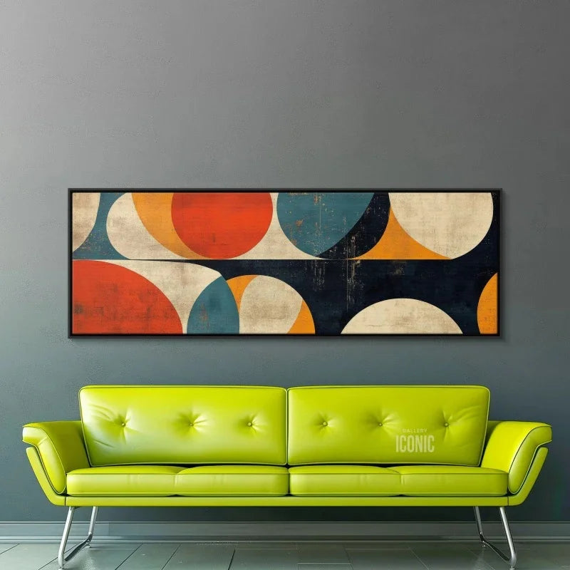 Green sofa in front of a wall with a colorful abstract painting