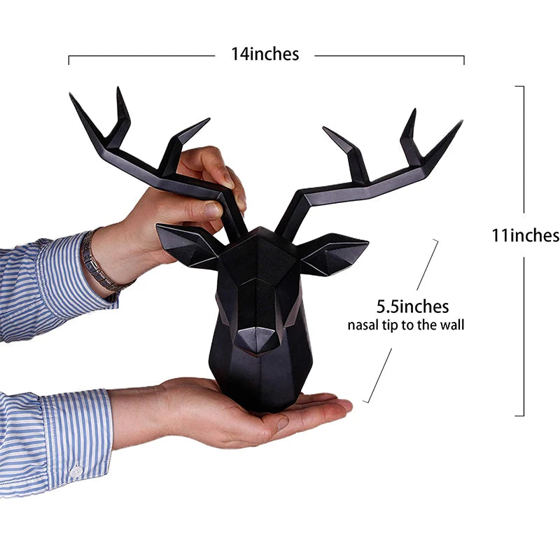 Black deer head wall decoration held by a person with measurements indicated.