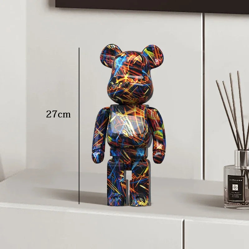 Colorful bear-shaped figure on a white surface with measurement label