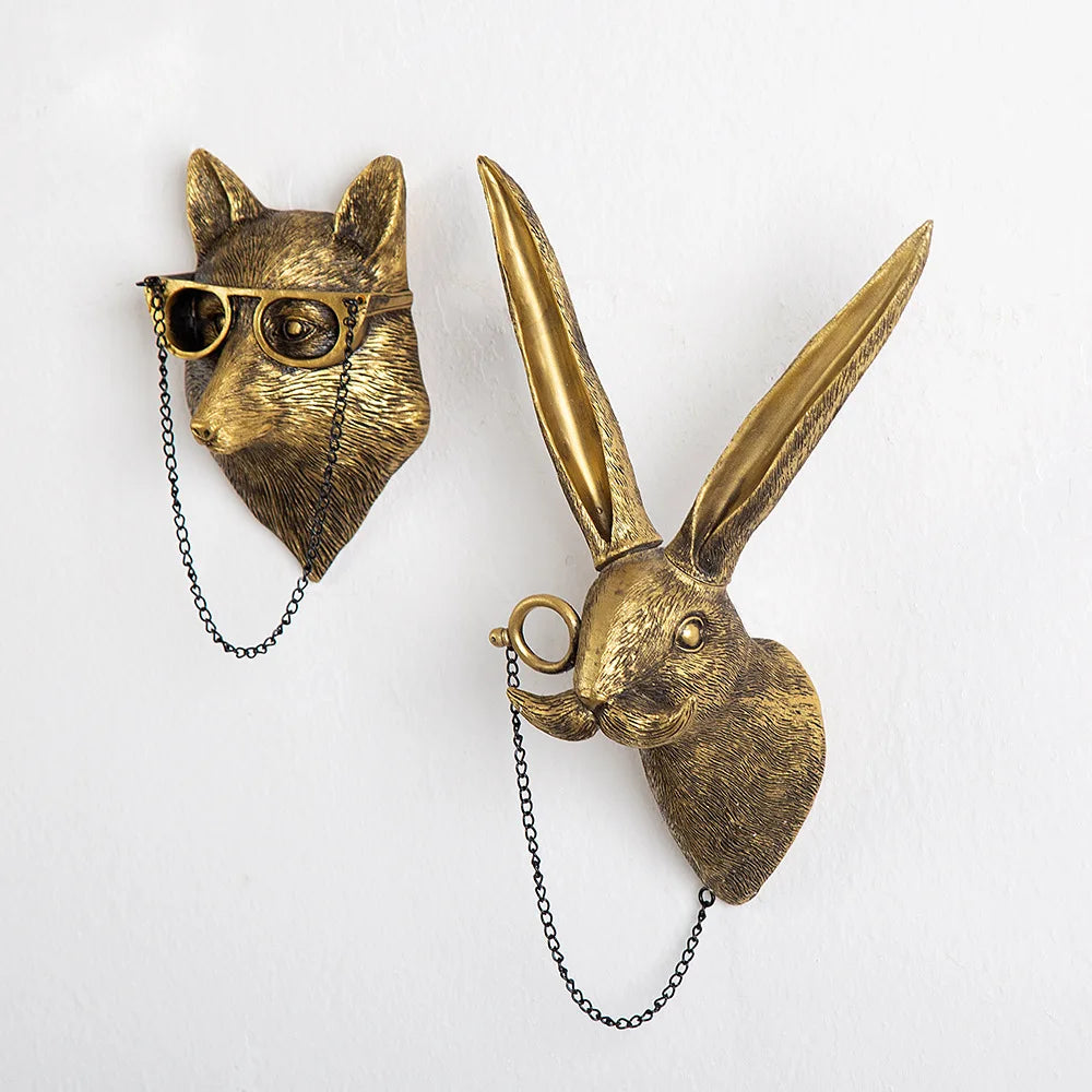 Bronze wall hooks shaped like a cat and a rabbit on a white background