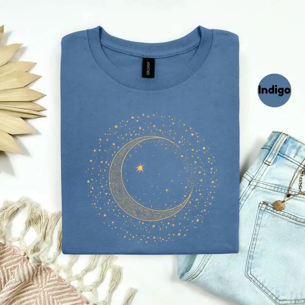Folded blue t-shirt with a celestial design on a white background