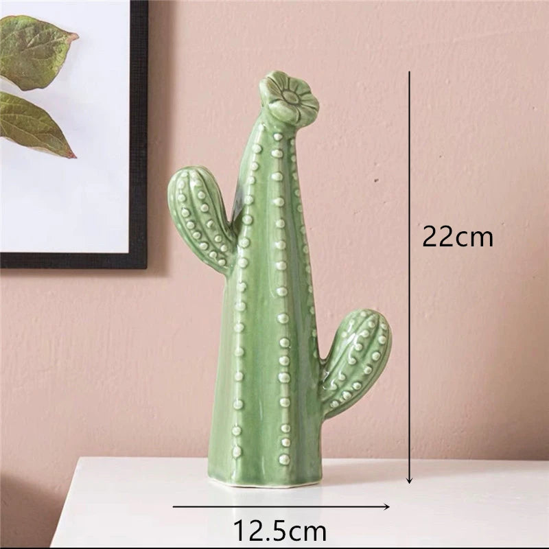 Green ceramic cactus decoration with measurements on a pink wall background
