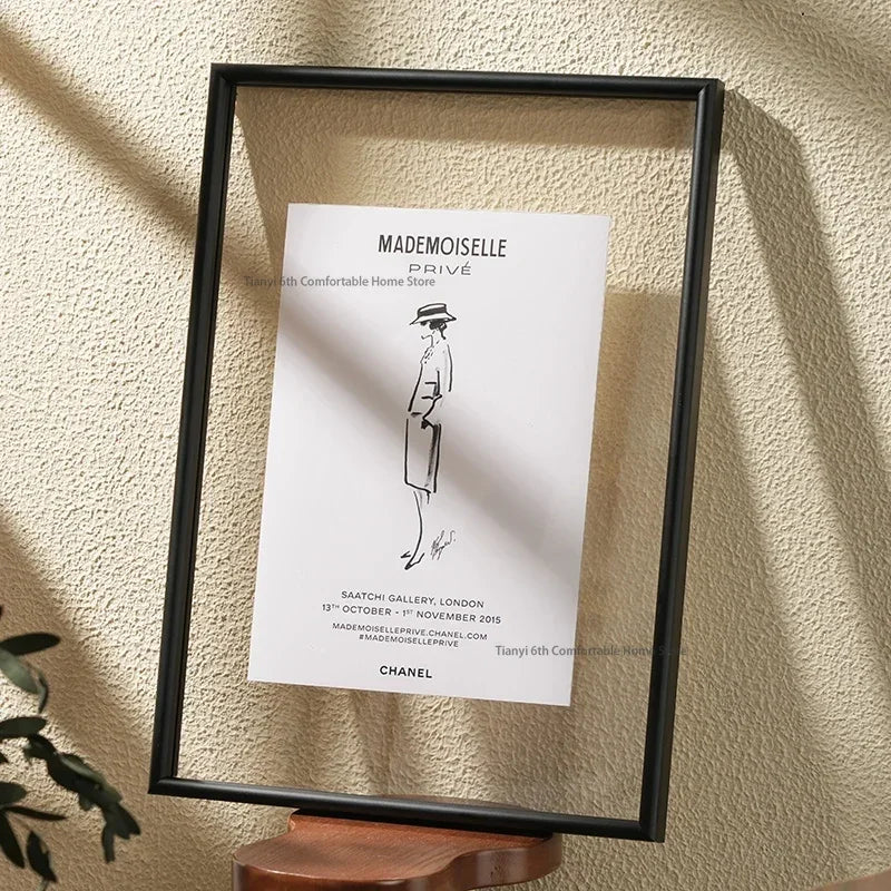Minimalist A4 transparent acrylic picture frame with aluminium border displayed on a shelf against a neutral wall