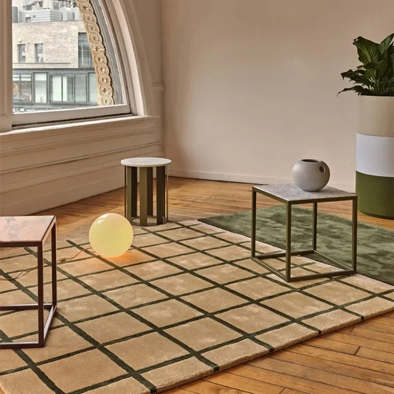 Living room with a patterned rug, small tables, and a plant.