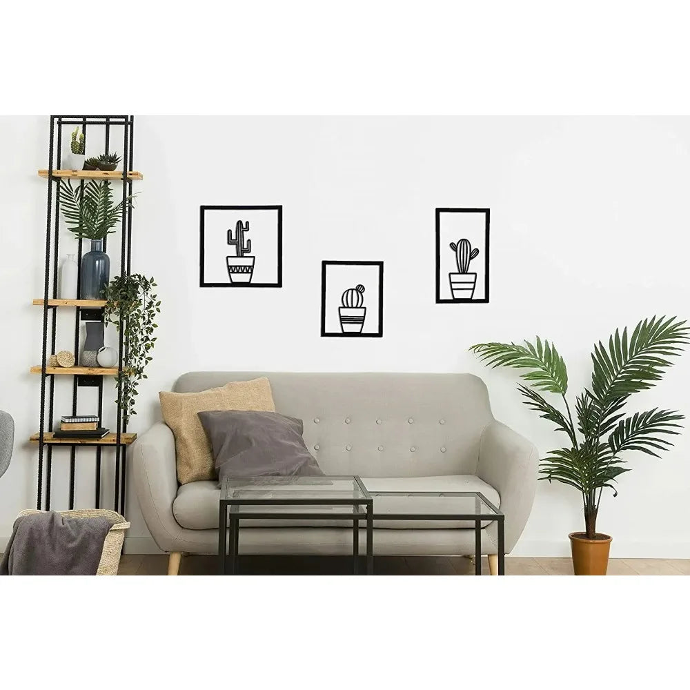 Modern living room with a grey sofa, decorative pillows, a coffee table, and Three piece black metal cactus wall art displayed on a grey wall