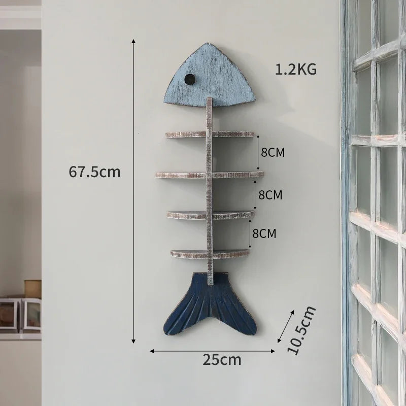 Wooden fish-shaped wall shelf with measurements on a white wall.