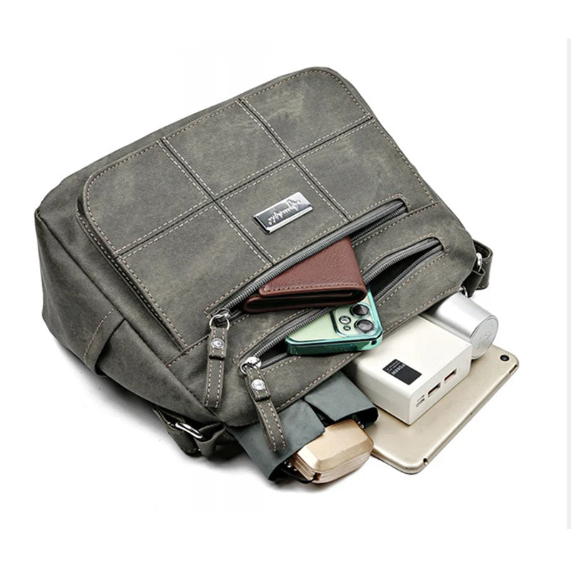 Women’s canvas crossbody shoulder bag with zip pockets and adjustable strap. Showing pockets available