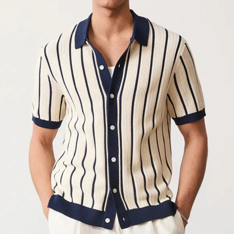 Man wearing a striped shirt with navy accents on a plain background