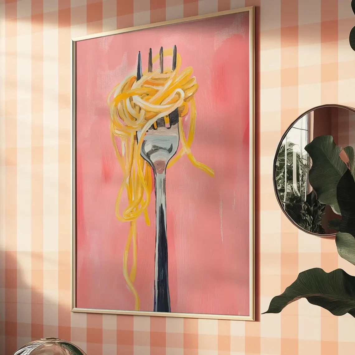 Framed artwork of a fork with spaghetti on a pink background, hanging on a wall with a checkered pattern.