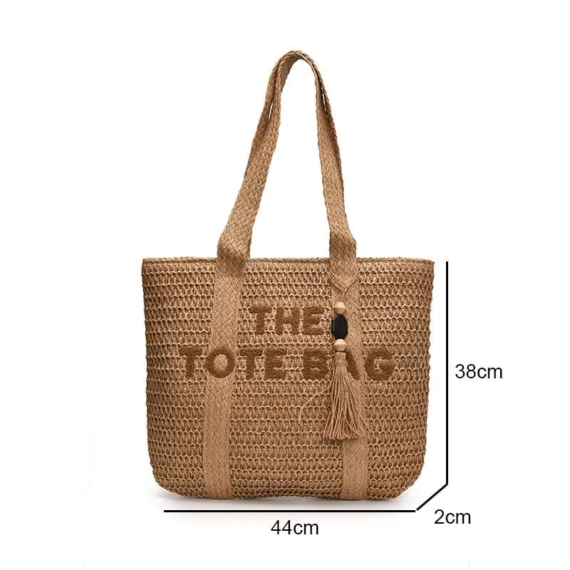 Woven handbag with 'THE LOVE' text and tassel, shown with dimensions on a white background.
