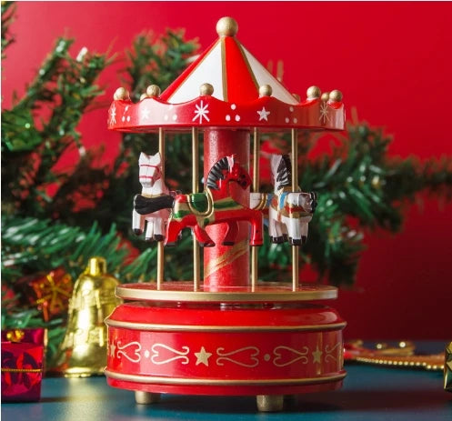 Red carousel toy with horses on a blue surface against a red background