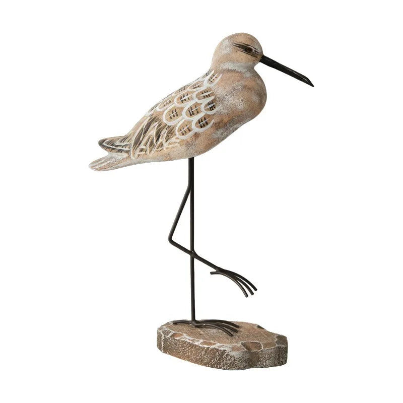 Decorative sandpiper bird sculpture on a white background