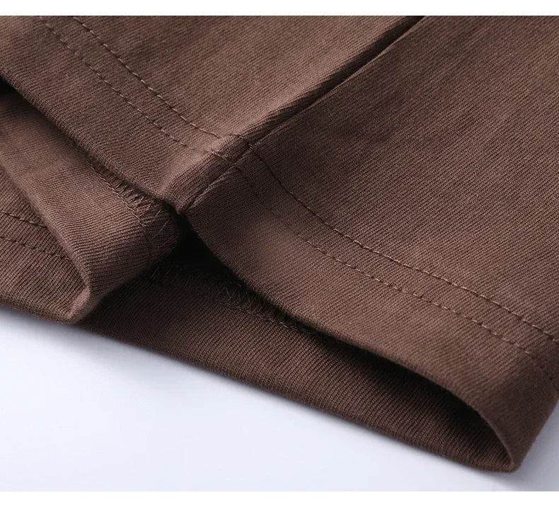 Close-up of brown fabric with visible stitching on a white background