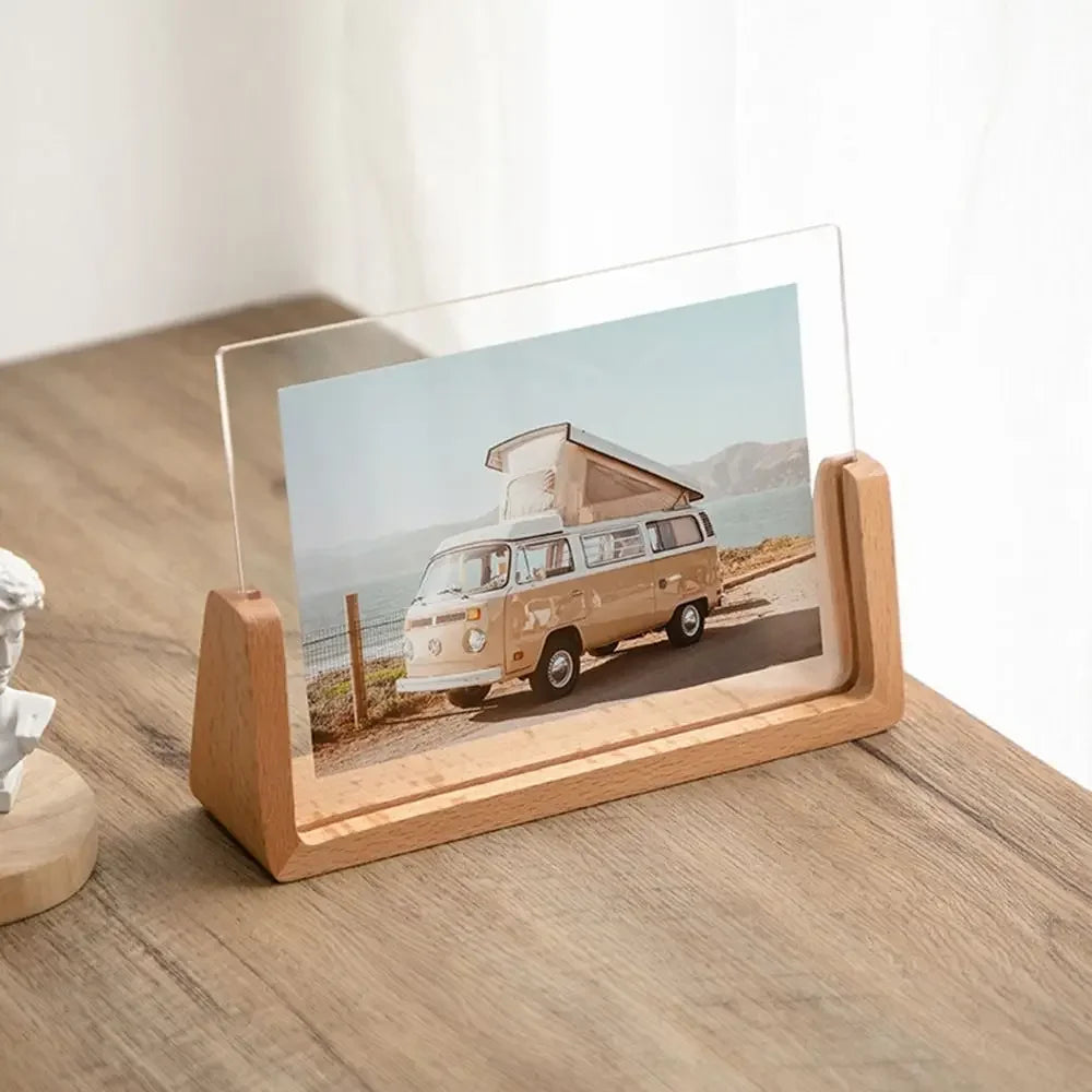 Wooden photo stand holding a picture of a vintage van on a wooden surface.