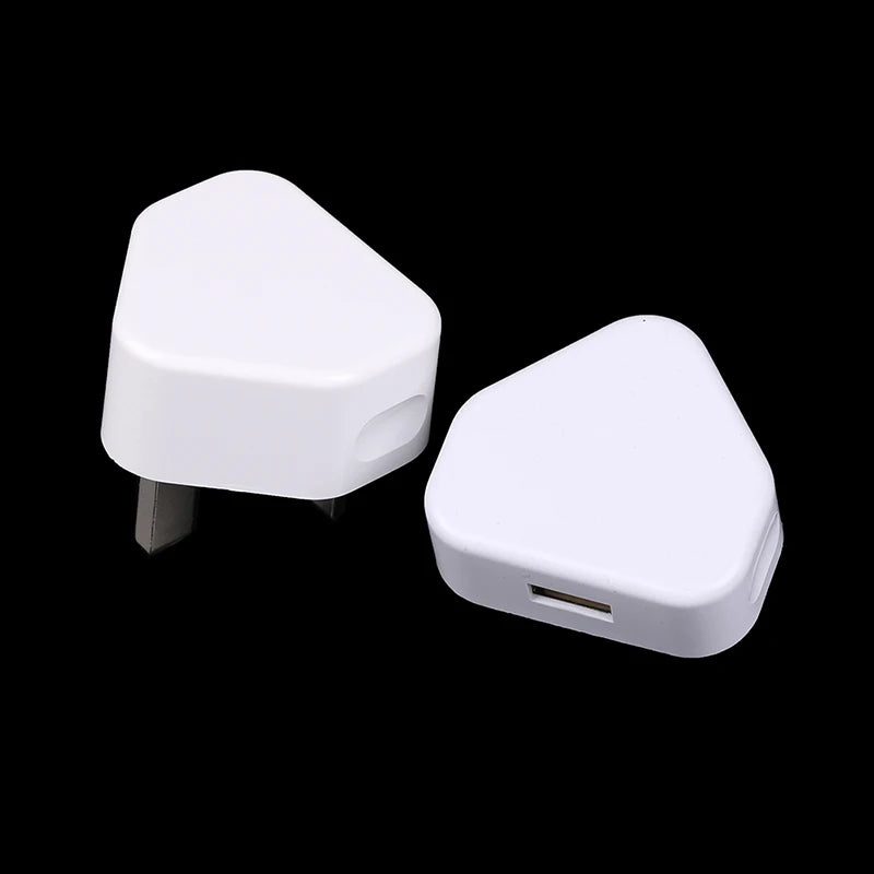 Two white triangular devices with USB ports on a black background