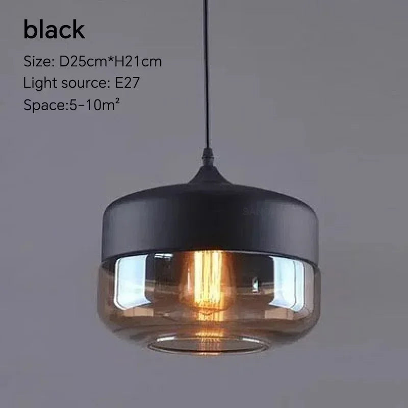 Black pendant light with clear glass shade on a gray background