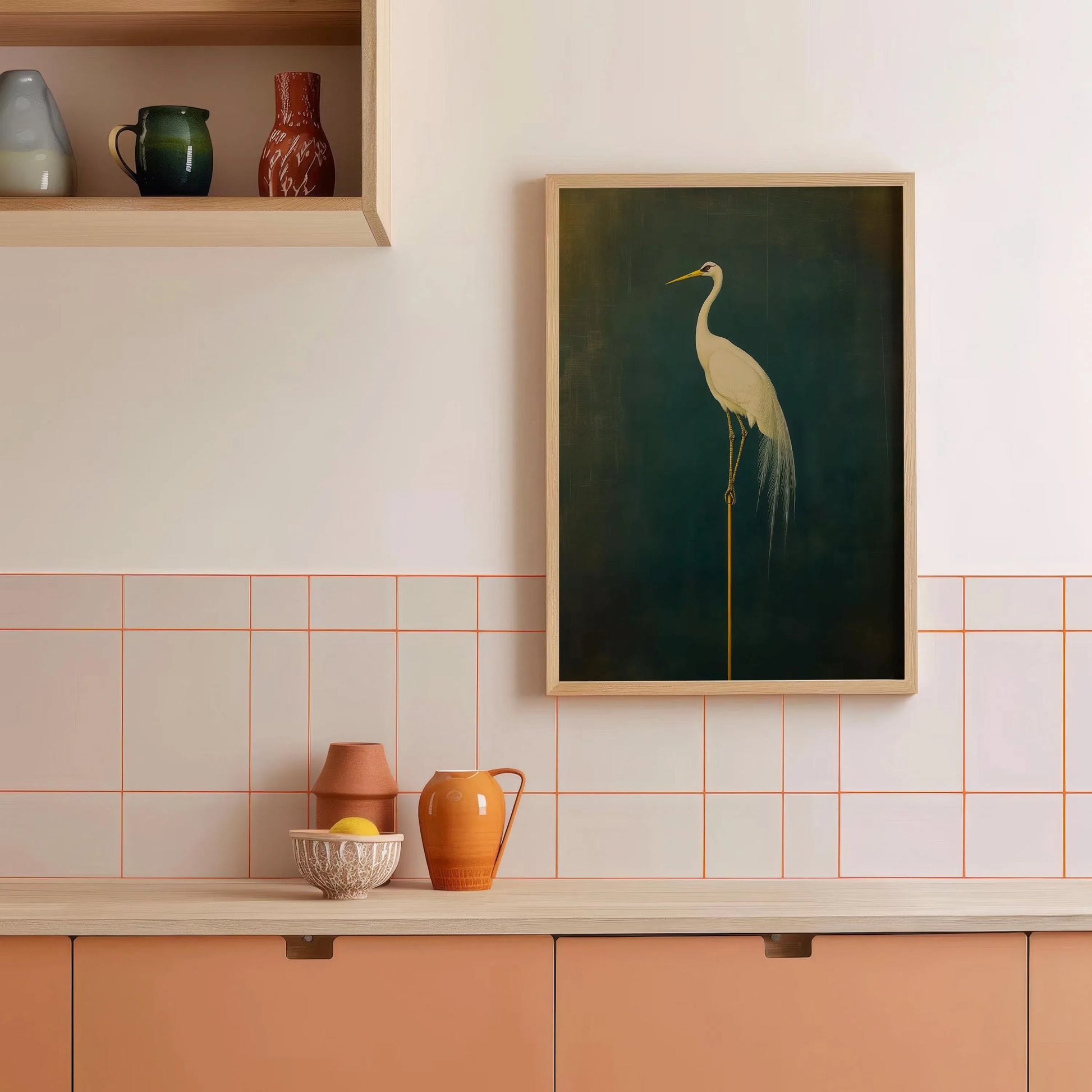 Framed artwork of a crane on a wall above kitchen cabinets with decorative vases.