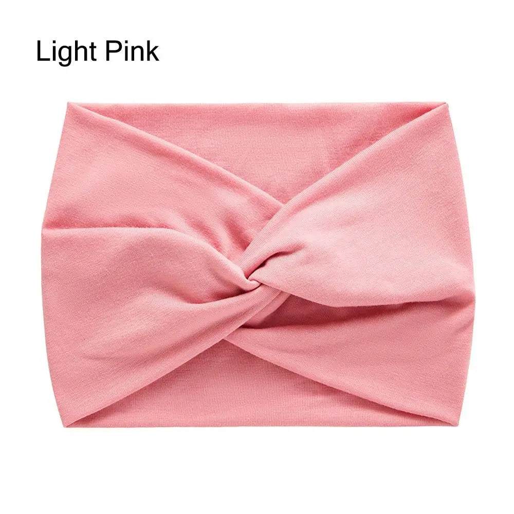 Light pink headband with a knot on a white background