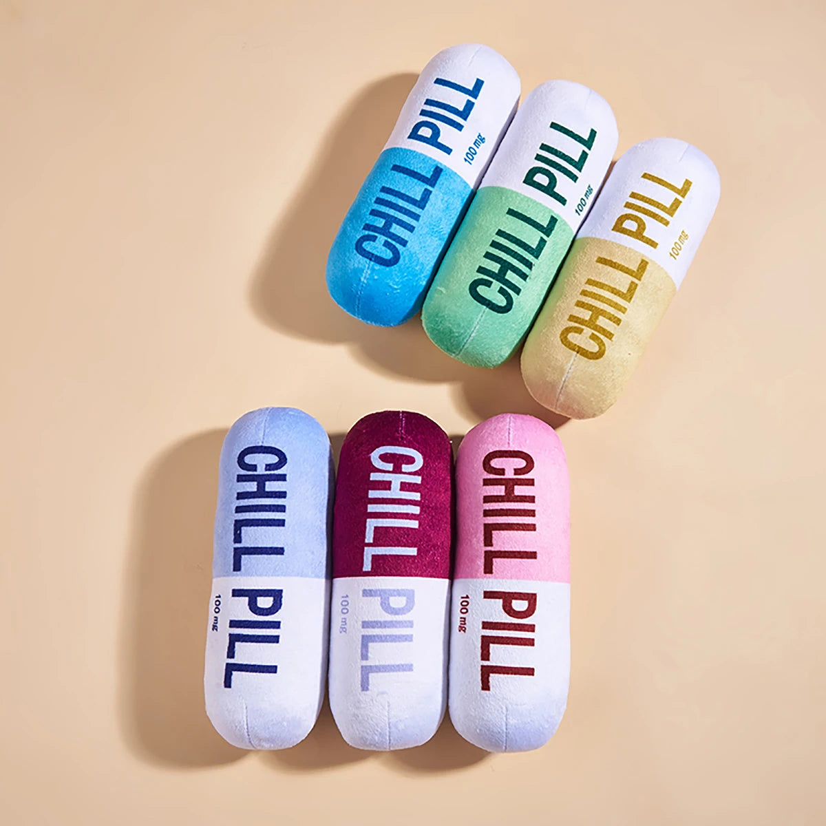 Colorful 'Chill Pill' cushions on a beige background