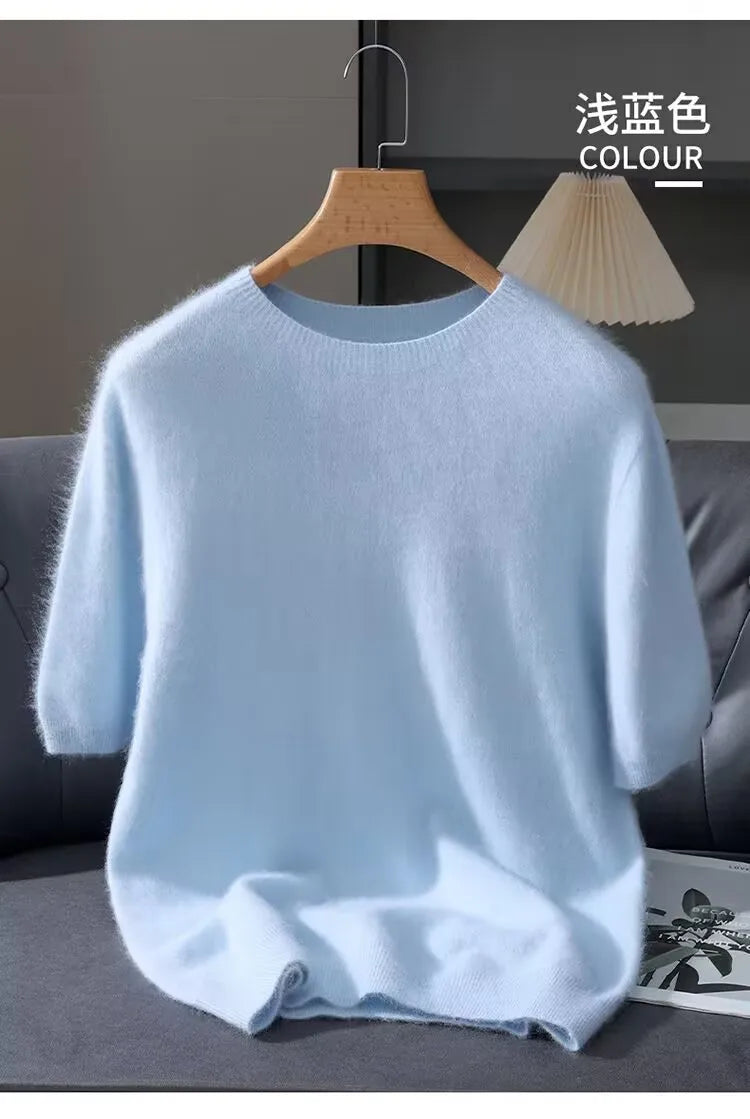 Light blue sweater on a hanger against a neutral background