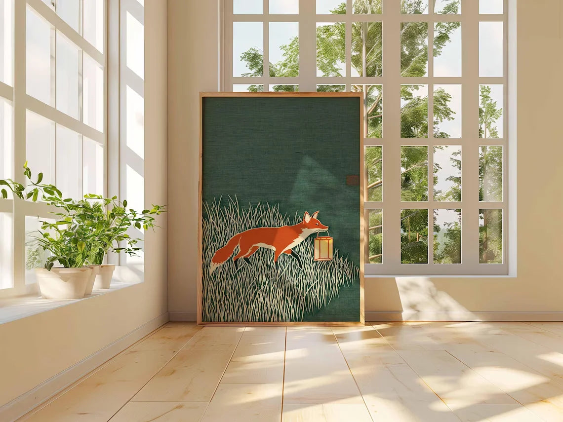 Minimalist Japanese-inspired fox art print showing an orange fox carrying a lantern through tall grass against a deep green background in a natural wood frame.