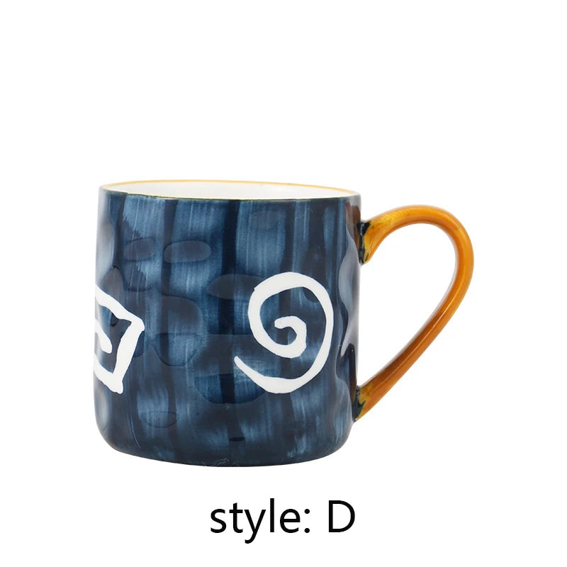 Blue mug with white spiral design and orange handle on a white background
