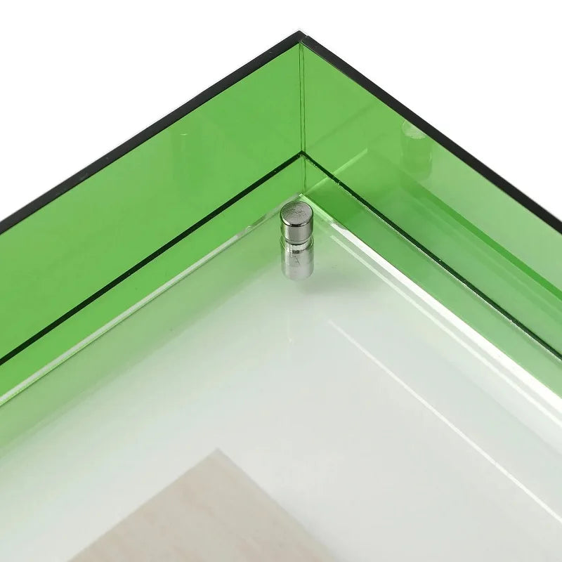Close-up of a transparent acrylic  corner frame with a bright green tinted panel and a small silver metal connector at the inner corner, shown on a white background.