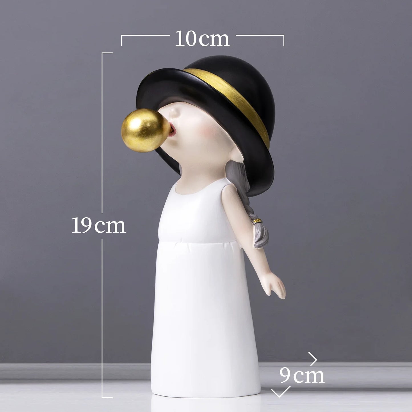 Decorative figurine with a black hat and gold ball, shown with measurements against a gray background.