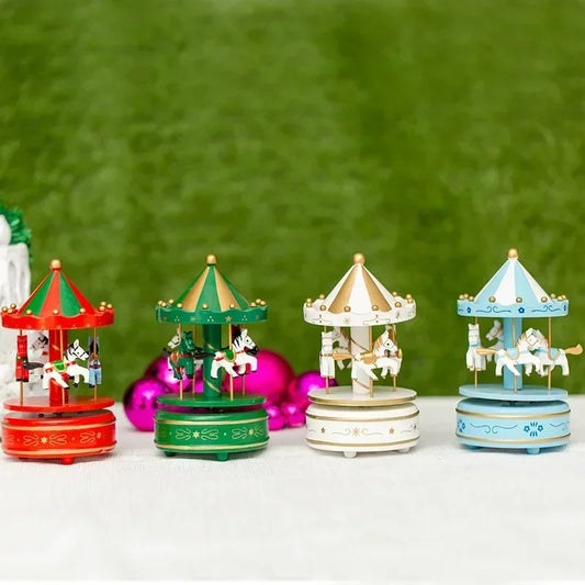 Four colorful carousel toys on a white surface with a green background