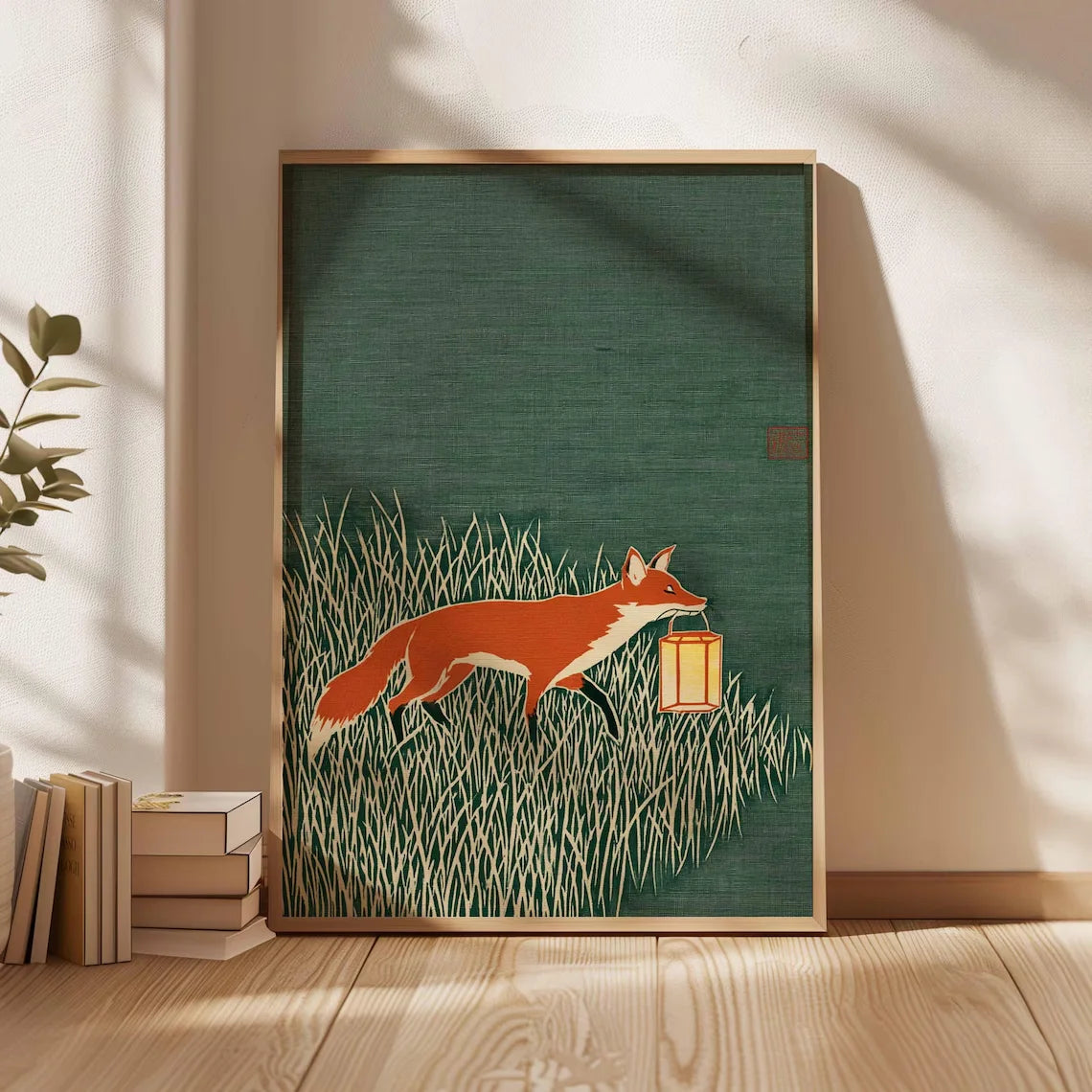 Minimalist Japanese-inspired fox art print showing an orange fox carrying a lantern through tall grass against a deep green background in a natural wood frame.