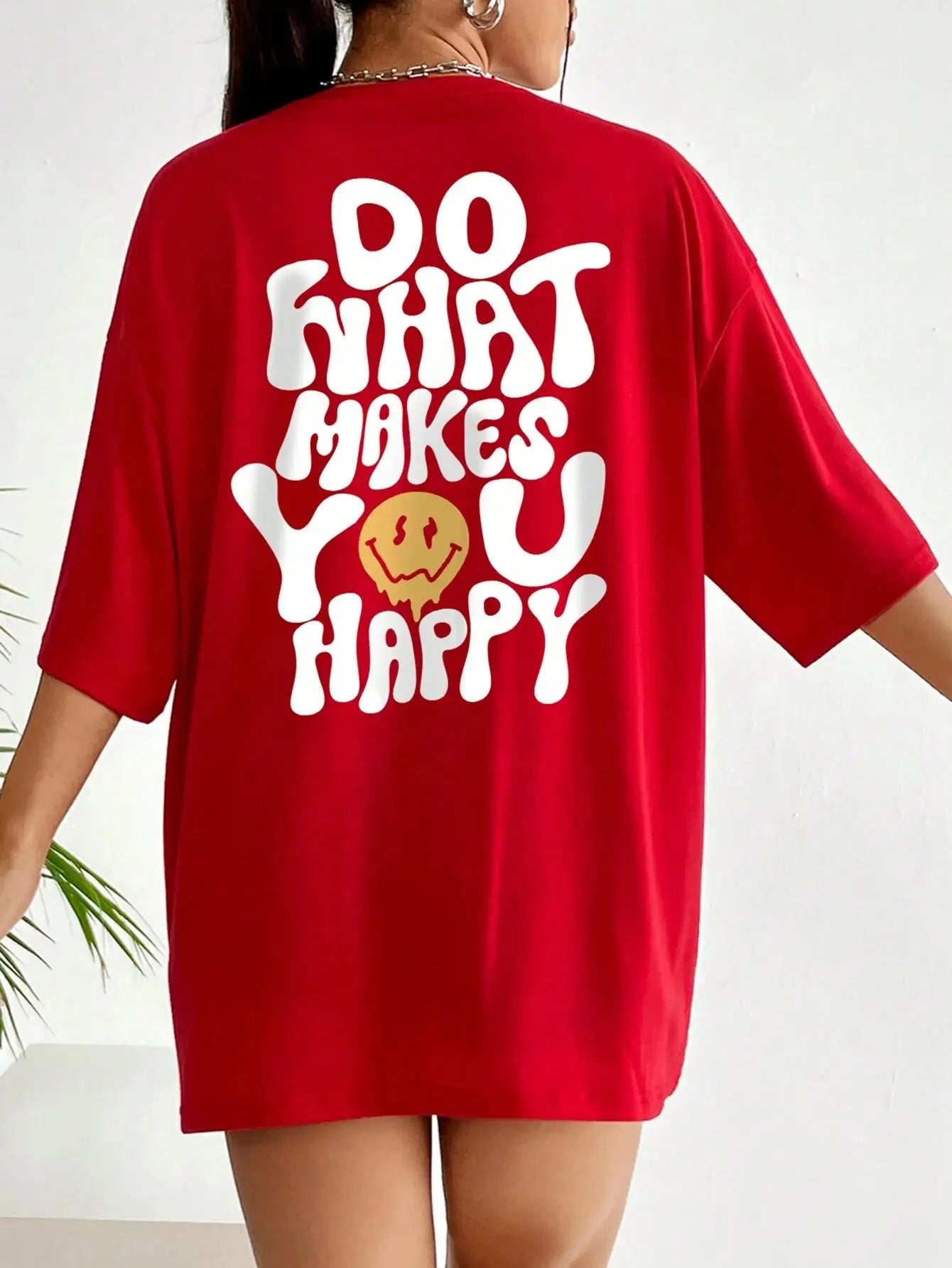 Red t-shirt with 'Do What Makes You Happy' text and smiley face on a white background