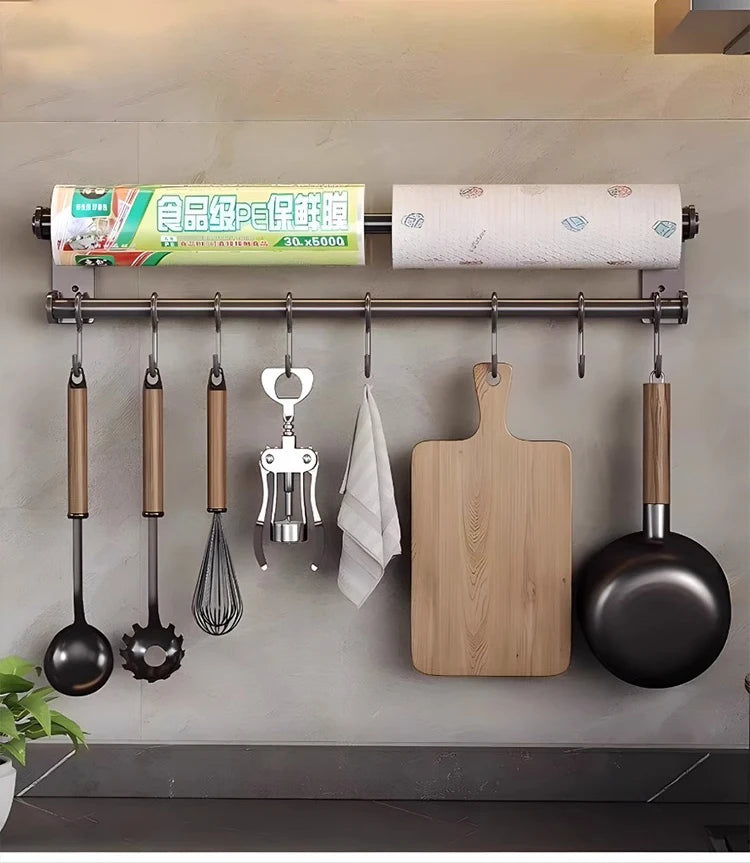 Kitchen wall organizer with utensils, cutting board, and pots on a gray wall.