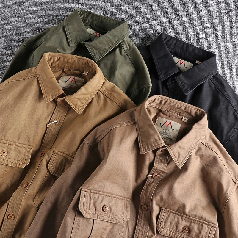 Four jackets in different colors arranged on a textured surface