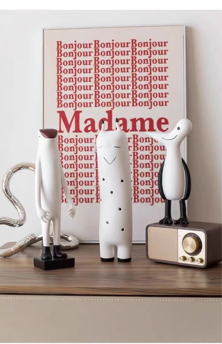 Decorative items on a shelf with 'Bonjour Madame' poster in the background