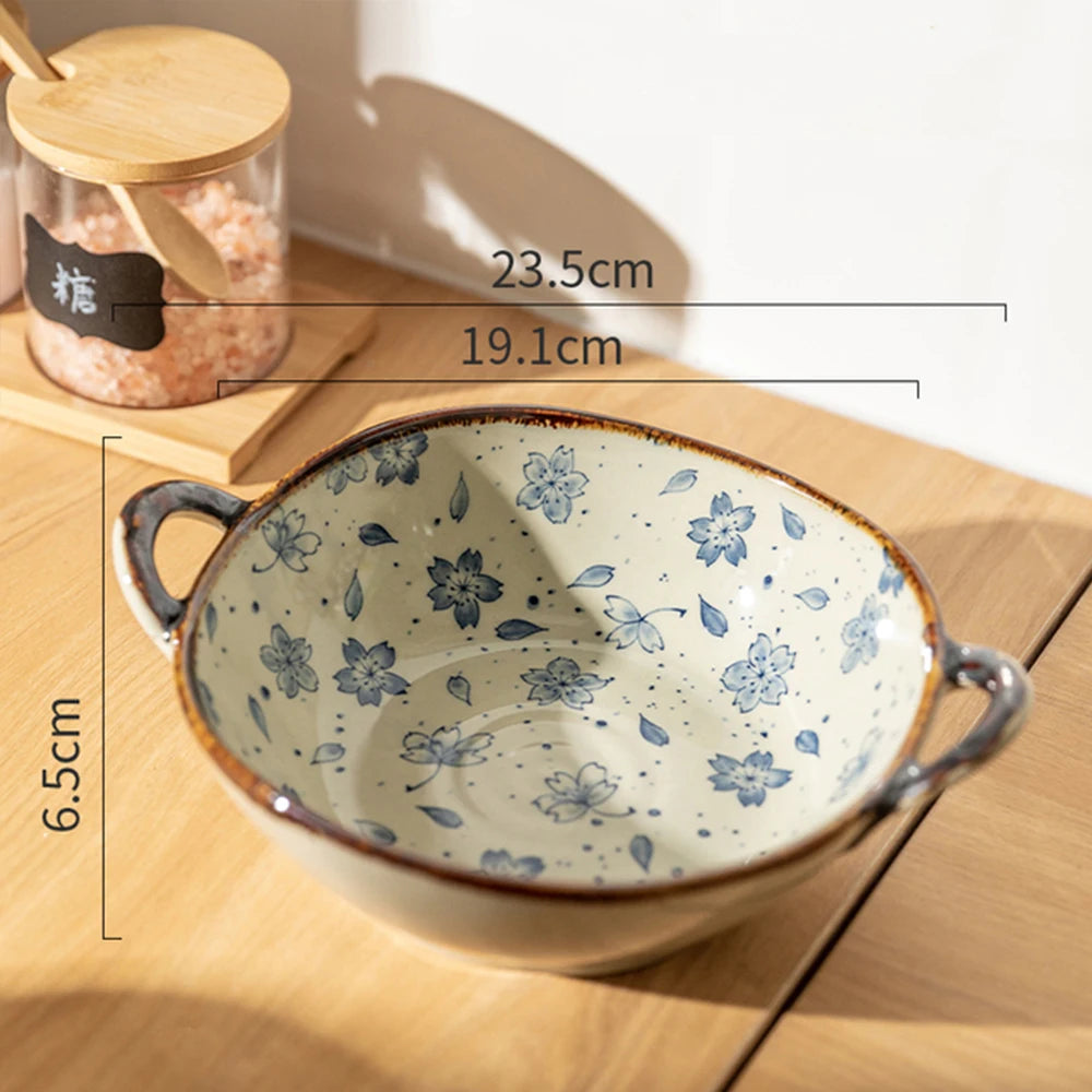 Ceramic bowl with floral pattern on a wooden surface, with measurements indicated.