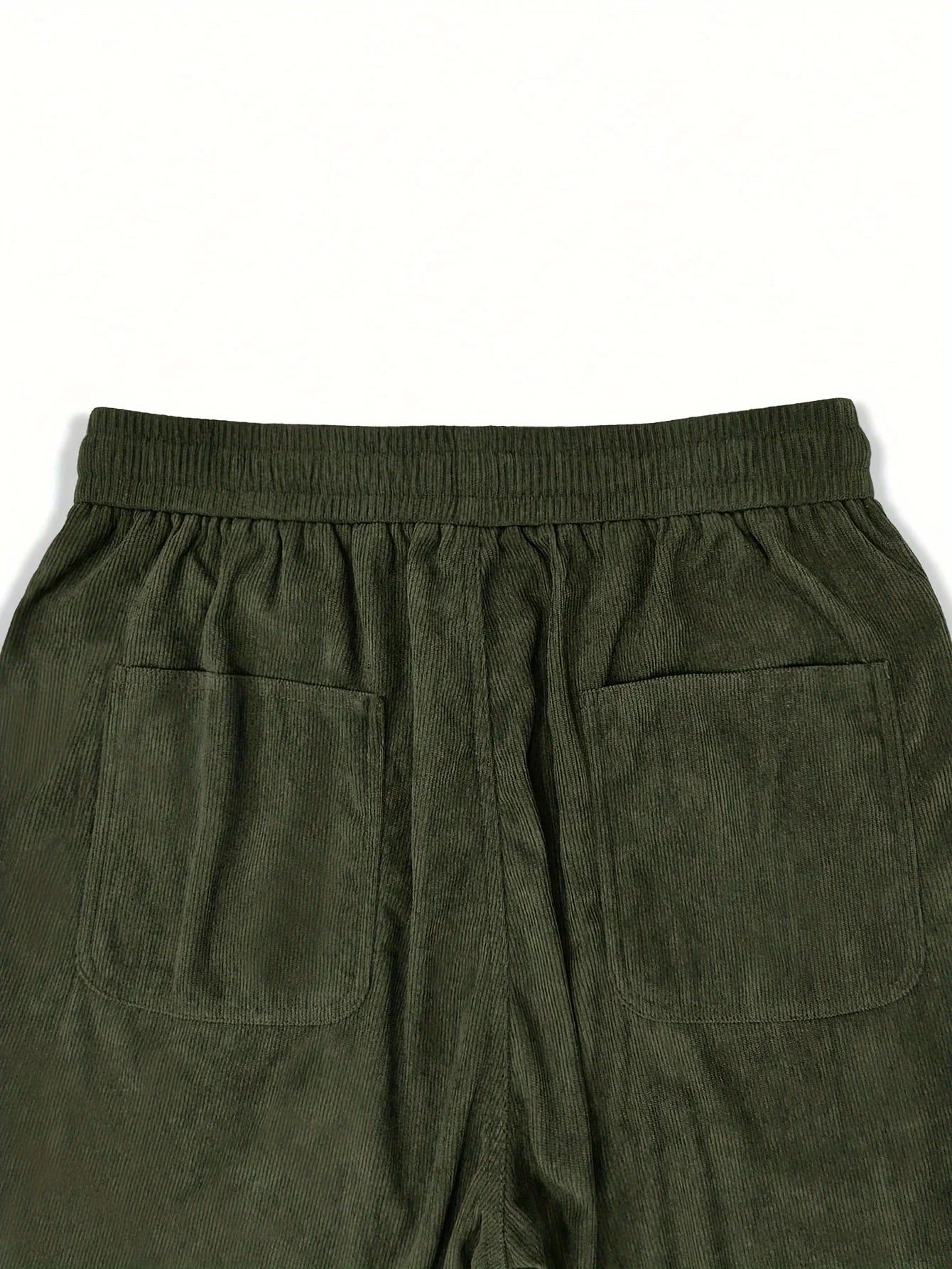 Green corduroy pants with pockets on a white background