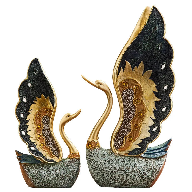Decorative swan figurines with intricate patterns on a white background