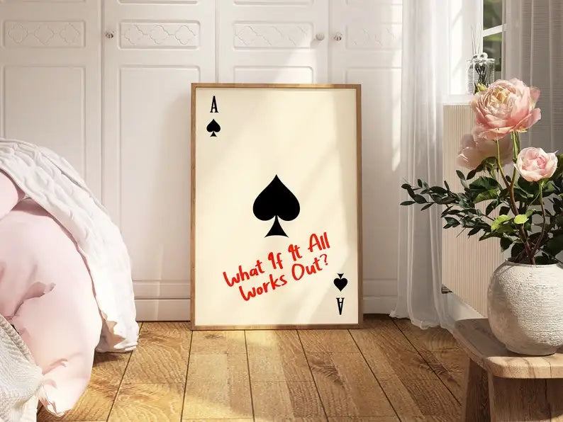 Framed playing card art with text in a room setting