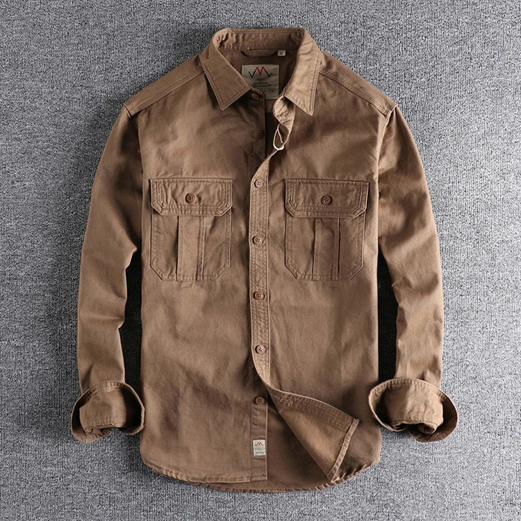 Brown shirt with rolled-up sleeves on a gray textured background