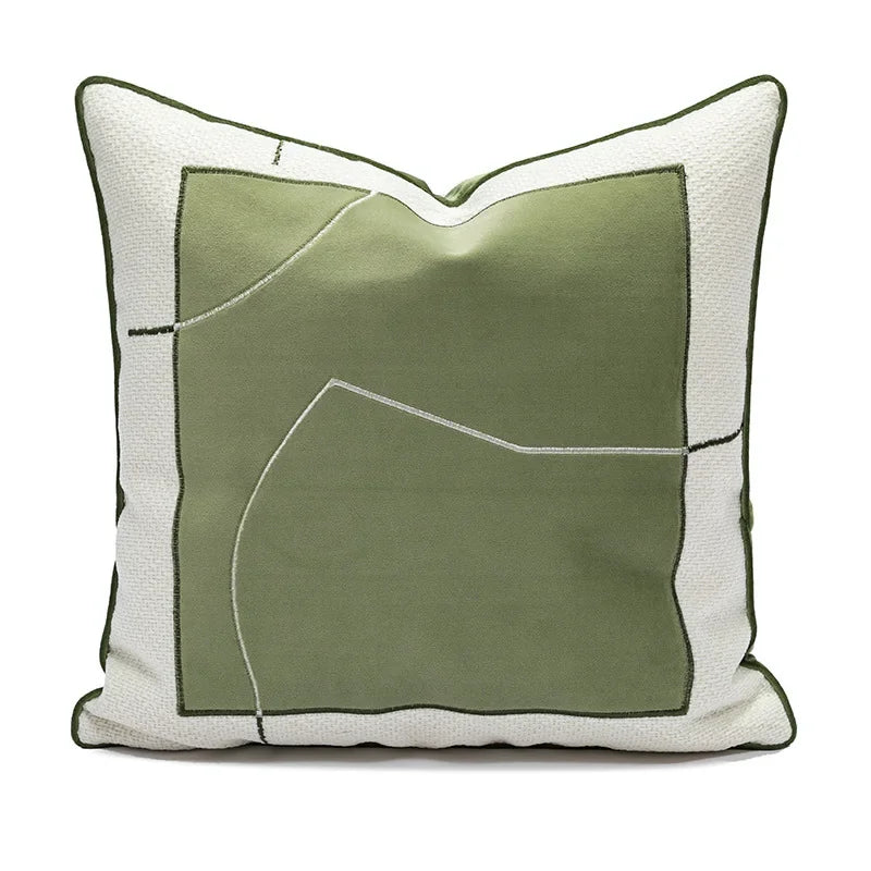 Decorative pillow with green and white design on a white background